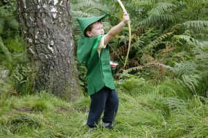 Child dressed as Robin Hood with a bow and arrow